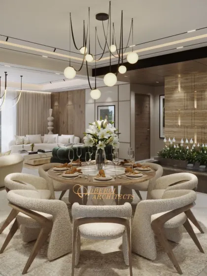 The dining area is defined by textured boucle chairs and a sculptural pendant light, creating an elegant setting for meals.