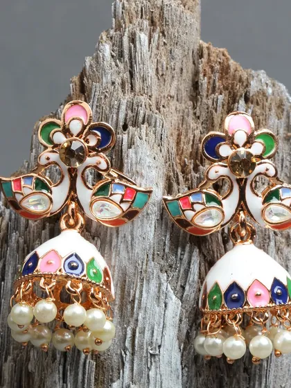 This multi-color peacock jhumka is a true masterpiece of meenakari art. The combination of white enamel with vibrant colors and hand-fixed pearls makes it a standout piece for any festive occasion.