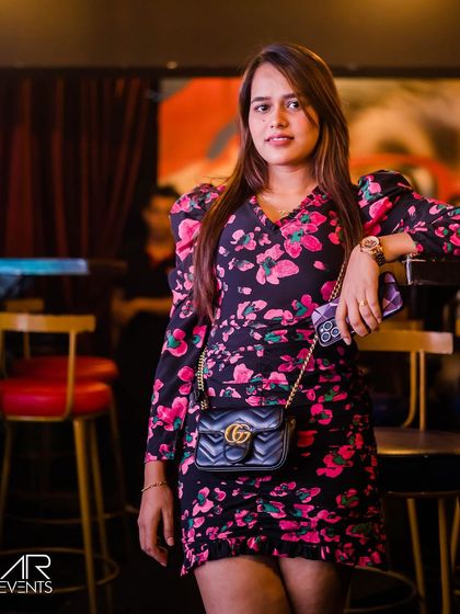 A guest in a floral top, looking happy and relaxed.