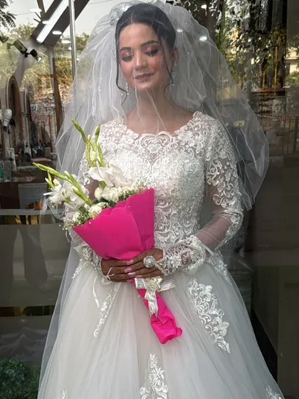 We also cater to Christian wedding aesthetics with elegant white gowns. This full-lace, long-sleeved ball gown with a delicate veil provides a classic and timeless look for pre-wedding shoots or bridal portfolios.