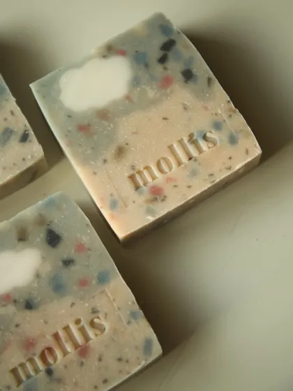 A close-up of the 'Sweet Fig' soap, highlighting the colorful soap confetti within.