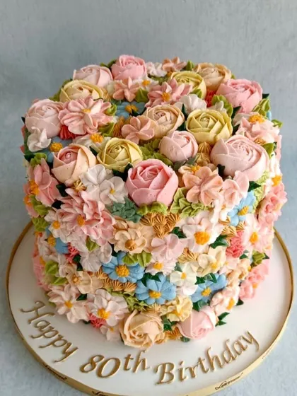 Another view of the stunning floral buttercream cake. The mix of colours and flower types creates a beautiful, natural look.