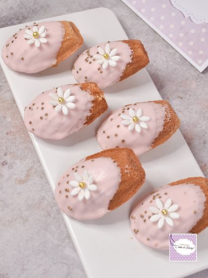French madeleines, dipped in pink chocolate and decorated with sugar daisies. These shell-shaped cakes added a touch of French elegance to the fairy garden spread.