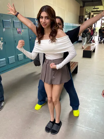 A playful moment with Khushi Kapoor behind the scenes. Her character's style was a mix of cute and preppy, like this off-shoulder top and mini skirt combo.