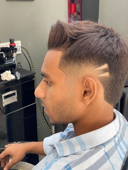 A modern take on a classic fade, featuring two parallel lines etched above the ear for a subtle but stylish detail.