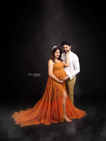 A romantic and dreamy portrait of the couple. The soft, smoky effect and the warm tones of the mustard gown create a cozy and intimate atmosphere.