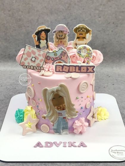 A pretty pink Roblox cake for a girl's 9th birthday. This design features girly Roblox avatars, a pink game controller, and cute button details.
