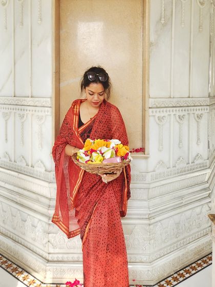 Another angle of the temple look, showing the saree drape and the offering of flowers.