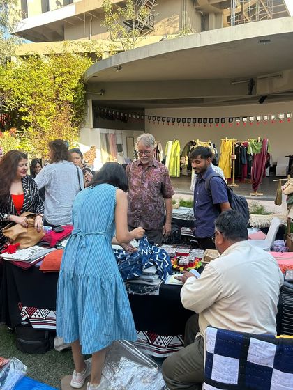 Visitors browsing the handcrafted goods at our stall during the Urmul Mela. These events provide a wonderful opportunity for direct interaction between our customers and artisans.