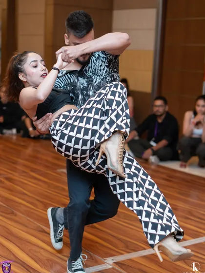 An action shot from the Kizomba competition, showcasing a dynamic lift and the athletic skill of our performers. Our training prepares dancers for high level performances.