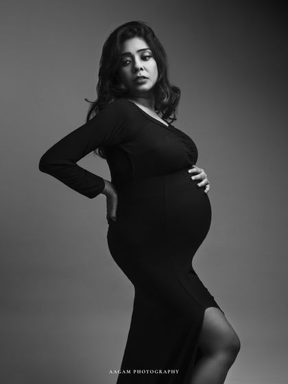 A powerful and confident pose in a black gown. The black and white treatment emphasizes her strength and the beautiful shape of her pregnancy.