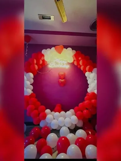 The classic combination of red and white is perfect for romantic occasions like a first night or an anniversary. This circular balloon arch with a neon sign creates a bold and passionate statement.