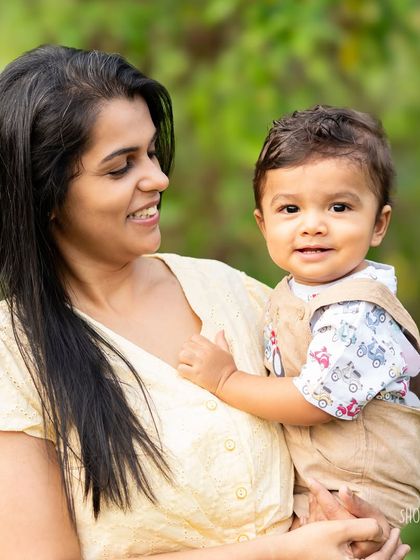A mother and her son enjoying a sunny day in the park. The warm, golden light of the outdoors adds a magical glow to this candid moment of connection.