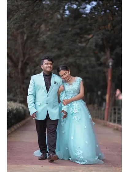 A quiet walk together. The gentle sway of the light blue ball gown adds a touch of grace to this couple's romantic stroll, perfect for a pre-wedding or engagement session.