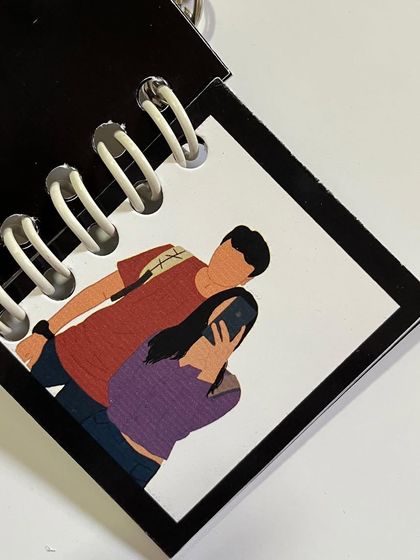A fun selfie moment captured as a faceless illustration in a mini booklet.