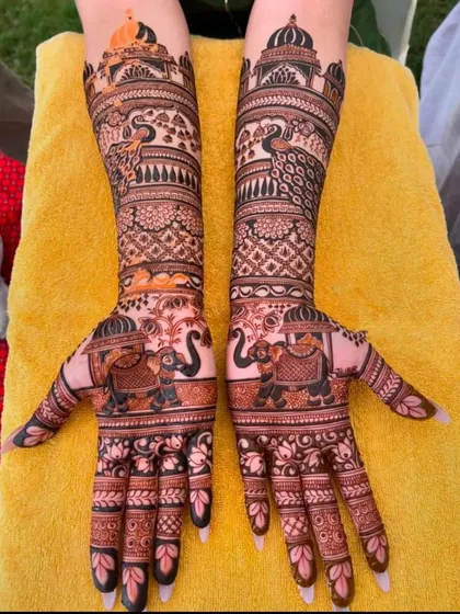 A beautiful bridal design with elephants on the palms and peacocks on the arms, all tied together with intricate traditional patterns.