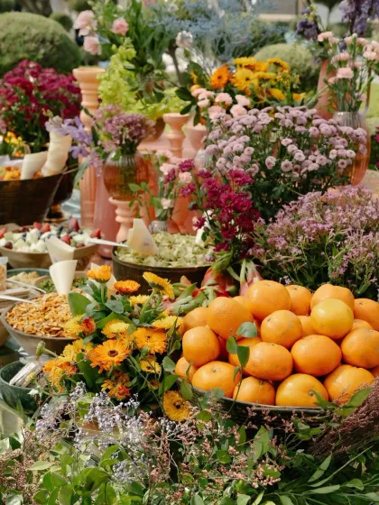 A close-up of a personalized Mehendi grazing table, where fresh fruits and flowers are integrated into the food display. Every detail is an opportunity for artistry and personal storytelling.