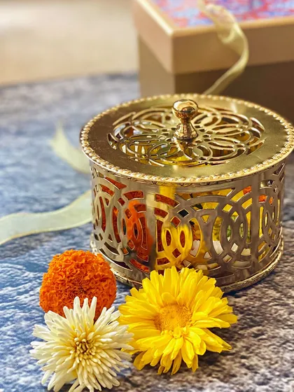 A wedding gift should feel both traditional and timeless. This intricate gold filigree box is a perfect example of a wedding favour that can hold sweets or trinkets, becoming a cherished keepsake for years to come.