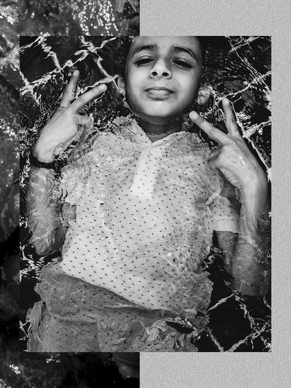 A cool black and white shot of a young guest floating in the pool, capturing the relaxed vibe of the party.