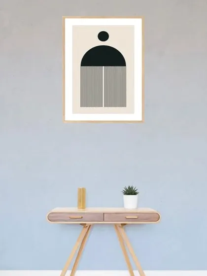 This single framed art print features a bold, geometric shape in black and white. The minimalist design is perfect for adding a touch of modern, graphic art to a console table or entryway.