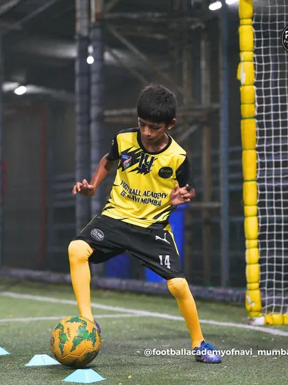 A player demonstrates excellent balance and control while dribbling through a cone exercise.