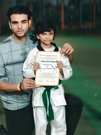 A student proudly displays his certificate of achievement from a recent tournament. Every competition is a valuable learning experience.