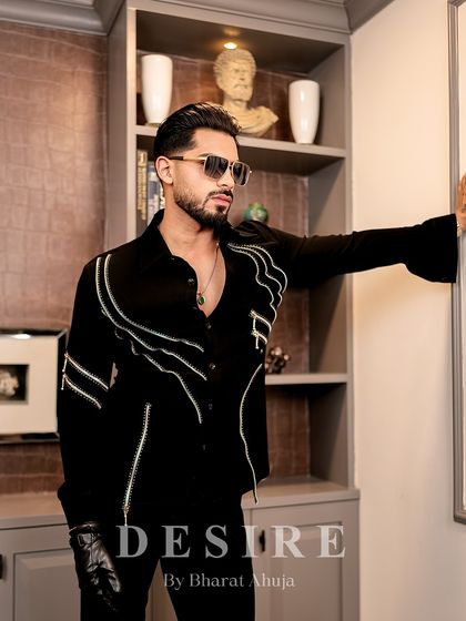 Another angle of the black zipper shirt, highlighting its modern design and the powerful silhouette it creates.