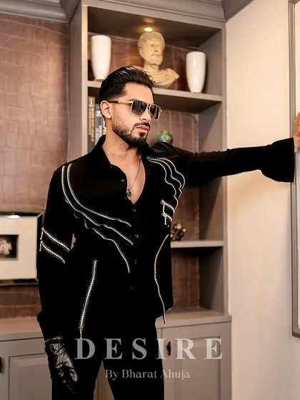 Another angle of the black zipper shirt, highlighting its modern design and the powerful silhouette it creates.