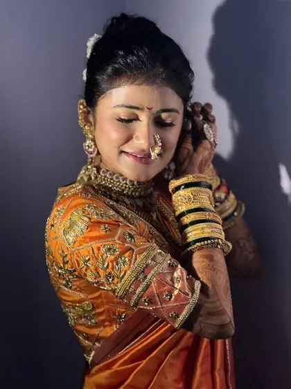 A bride getting ready on her wedding day. The makeup is soft and elegant, designed to make her feel confident and beautiful.