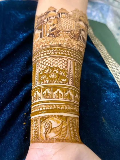 A full arm design featuring a royal elephant procession and lotus motifs. The different sections are separated by beautiful, intricate borders.