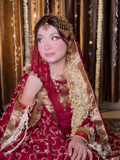 A portrait of the bride looking away, showcasing her side profile and the intricate details of her hair jewelry.