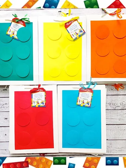 The handmade LEGO-style paper bags are a perfect match for the building block gifts, complete with personalized thank you tags.