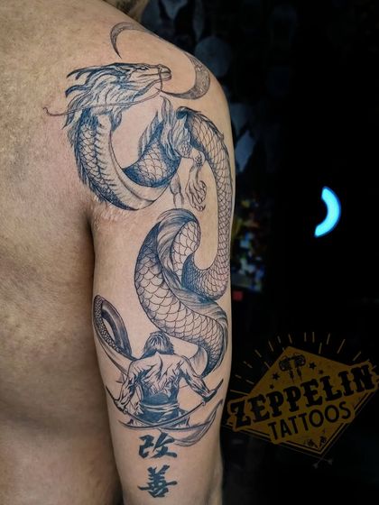 A warrior facing a dragon, a classic theme of courage and challenge. This half-sleeve was designed to tell a story of inner battles and strength.