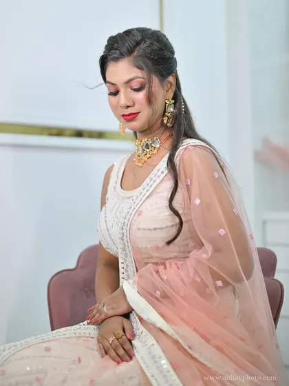 A close-up of a delicate pink and white lehenga. The subtle embroidery and soft colors make it a graceful choice for a daytime event.