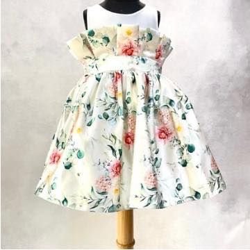 A back view of the "Floral Grace" dress, showing the paper-bag waist detail and the full, pleated skirt perfect for twirling.