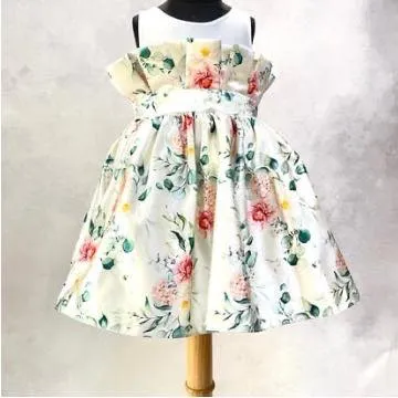 A back view of the "Floral Grace" dress, showing the paper-bag waist detail and the full, pleated skirt perfect for twirling.