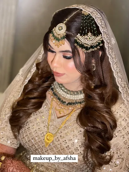 A close-up of the beautiful makeup and hair for this bride. The soft curls and dupatta setting are just perfect.