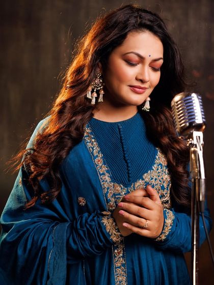 Another angle of Priyanka Barve at the vintage microphone, emphasizing the performance aspect of her photoshoot.