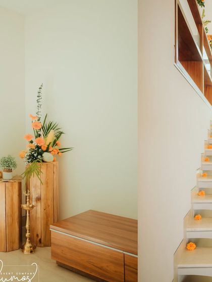 A minimalist corner of the house, with wooden pedestals and simple floral arrangements.