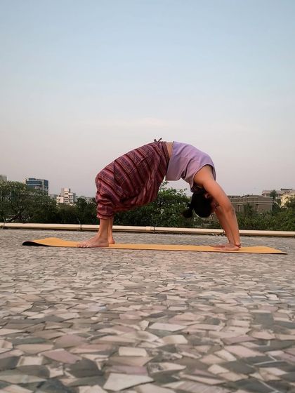 Chakrasana (Wheel Pose) is an invigorating backbend that opens the chest and shoulders, building strength and flexibility in the spine.