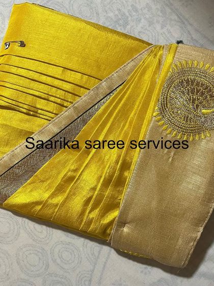 This bright yellow saree with an embroidered pallu is folded carefully to protect the delicate threadwork.