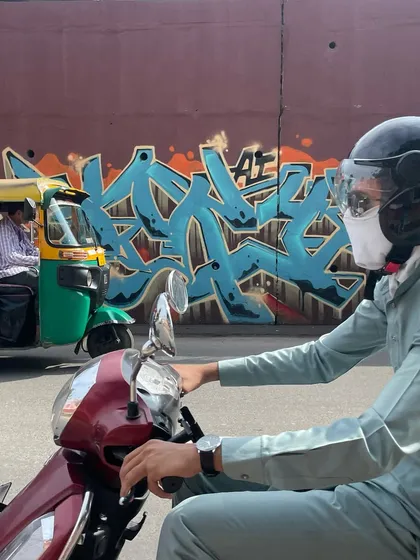A rider passing by the Ahmedabad piece. I love seeing my work integrated into the motion of the city. It's not just on a wall, it's in the world.