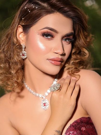 A close-up of the cocktail makeup look, featuring dramatic eyes with pearl accents and a glossy lip.