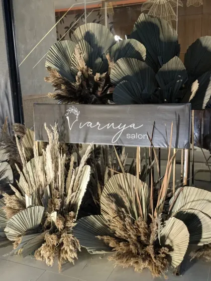 We use decor to tell your brand's story. This setup for Varnya Salon features a custom sign and earthy, dried floral arrangements, creating a welcoming and on-brand atmosphere for their launch event.