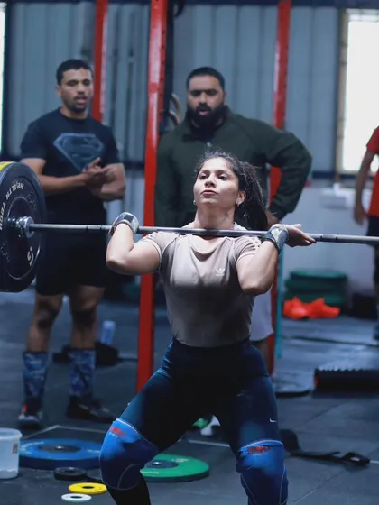 The intense focus of an athlete in the middle of a heavy clean. Every detail matters when the weights get heavy.