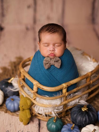 Adding a tiny bowtie gives this classic swaddled pose a touch of dapper charm.