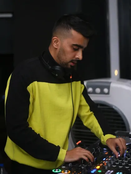 In my element, mixing tracks at Flo. The yellow and black outfit adds a pop of color to the night.