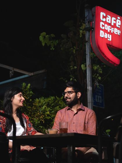 A candid shot of a couple on a date at Cafe Coffee Day. This lifestyle approach to pre-wedding photography captures the couple in a natural, everyday setting.