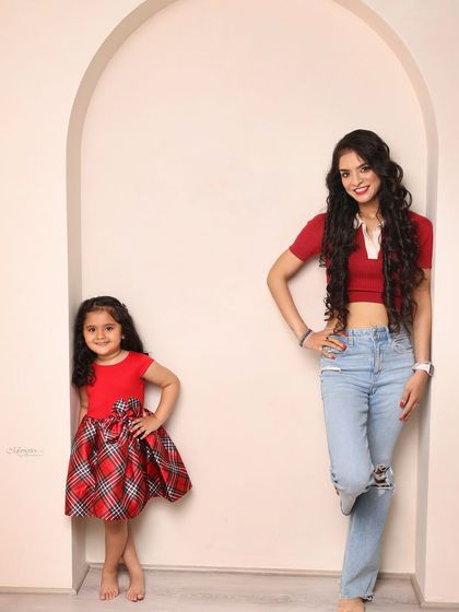 Posing like pros. This mother-daughter duo shows off their style and confidence in this fun, coordinated shot.