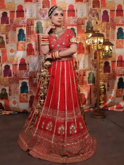 Another elegant full-length pose that captures the complete bridal attire. The jewellery stands out, highlighting the bride's features and complementing her outfit perfectly.